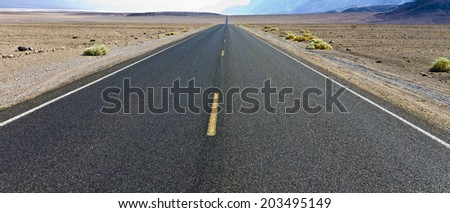 driving on the Interstate 187 in Death valley direction Badwater in the heat of the Mojave Desert
