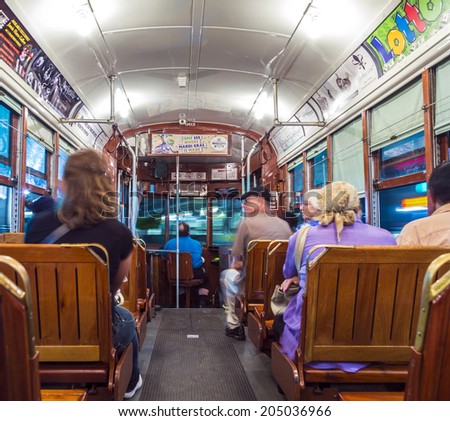 NEW ORLEANS - JULY 14, 2013: people travel with the famous old Street car St. Charles line  in New Orleans, USA. It is the oldest continually operating street car line in the world.