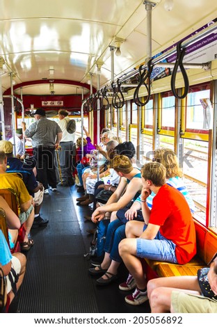 NEW ORLEANS - JULY 15, 2013: people travel with the famous old Street car St. Charles line in New Orleans, USA.  It is the oldest continually operating street car line in the world.