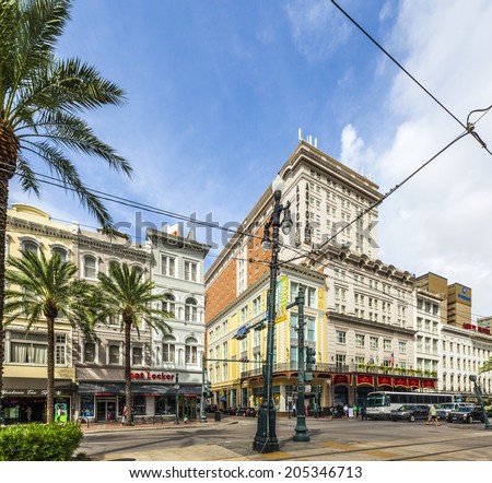 NEW ORLEANS - JULY 16, 2013: crossing canal street with bourbon street and famous Astor hotel in New Orleans, USA. The Astor boasts of 693 hotel rooms and over 32,000 square feet of meeting rooms.