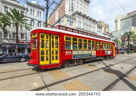 NEW ORLEANS - JULY 16, 2013: people travel with the old Street car Canal street line St. Charles line  in New Orleans, USA.  It is the oldest continually operating street car line in the world.