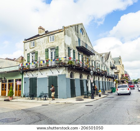 NEW ORLEANS, USA - JULY 17, 2013: people visit historic building in the French Quarter in New Orleans, USA. Tourism provides a large source of revenue after the 2005 devastation of Hurricane Katrina.