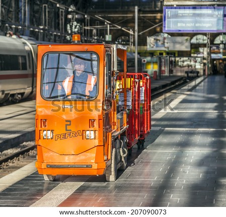 FRANKFURT, GERMANY - MARCH 2, 2013:   railway man transports goods in an electric car at the railway station in Frankfurt, Germany. They station was build as a  dead-end station in 1886.