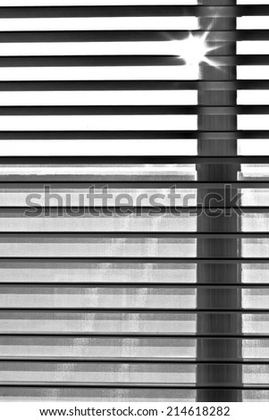 shutter blind of a window in sunshine gives harmonic shadow