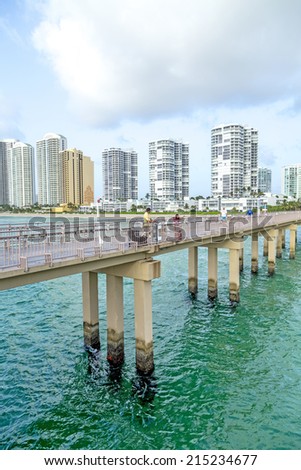 SUNNY ISLES BEACH, USA - AUG 17, 2014: people catch fish at  the pier in Sunny Isles Beach, USA. In 1936, Milwaukee malt magnate Kurtis built the Sunny Isles pier.