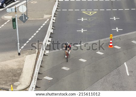 COLOGNE, GERMANY- SEP 7, 2014: An athlete cycles in the Cologne Triathlon in Cologne, Germany. The event takes place first in 1984 and is performed yearly in the City area of Cologne.