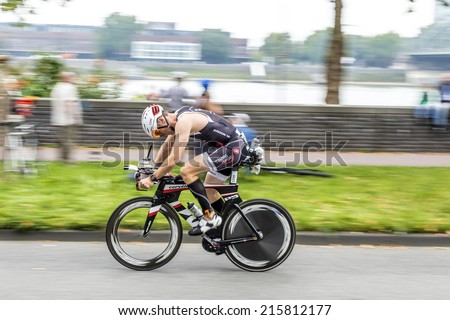 COLOGNE, GERMANY- SEP 7, 2014: An athlete cycles in the Cologne Triathlon in Cologne, Germany. The event takes place first in 1984 and is performed ince then yearly in the City area of Cologne.
