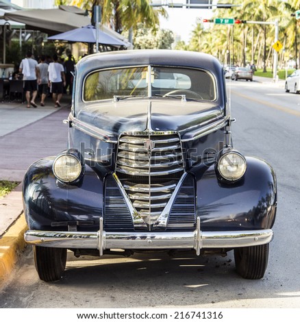 MIAMI, USA - AUG 19, 2014: classic Oldsmobile parks in front of the Hotel Park Central in Miami, USA. Built in 1937, The Park Central is known as The Blue Jewel of Ocean Drive.