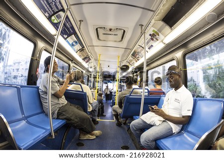 MIAMI, USA - AUG 18, 2014: people in the downtown Metro bus in Miami, USA. Metrobus operates more than 90 routes with close to 1,000 buses covering 41 million miles per year.