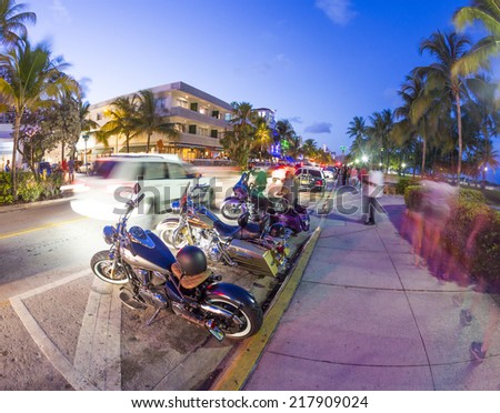 MIAMI, USA - AUG 23, 2014: Palm trees and art deco hotels at Ocean Drive by night. The road is the main thoroughfare through South Beach in Miami, USA.