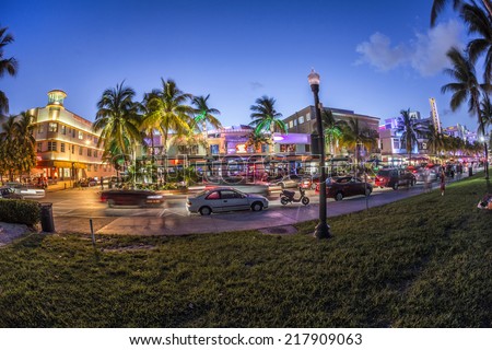 MIAMI, USA - AUG 23, 2014: Palm trees and art deco hotels at Ocean Drive by night. The road is the main thoroughfare through South Beach in Miami, USA.