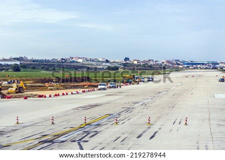 LISBON, PORTUGAL - DEC 30, 2008: people repair runway of the airport in Lisbon, Portugal. Lisbon Portela Airport, is the main international gateway to Portugal and opened first in 1942.