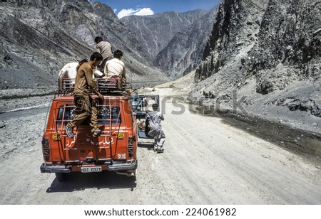 GILGIT, PAKISTAN - JUNE 30, 1987: people on a car stop because of a landslide in Gilgit, Pakistan. The Karakoram Highway is the only street to china and often interrupted by landslides.
