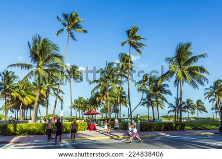 MIAMI, USA - AUG 23, 2014: people walk along the promenade at ocean drive at Miami, USA. Ocean drive is the most popular street in South Beach.
