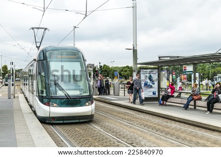 ILLKIRCH, FRANCE - JULY 4, 2013: people wait for train to Strasbourg in Illkirch, France. Illkirch ist the park and ride station for Strasbourg.