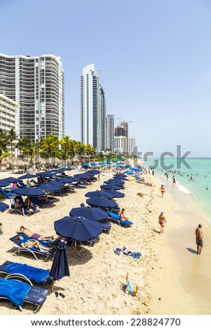 SUNNY ISLES BEACH, USA - AUG 2014: people at Jade beach in Sunny Isles Beach, USA. Jade Beach and Ocean were completed in 2009 with a elevation of 549 feet located at 170th Street.