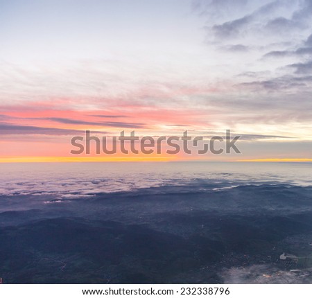 spectacular sunrise over the clouds seen from aircraft