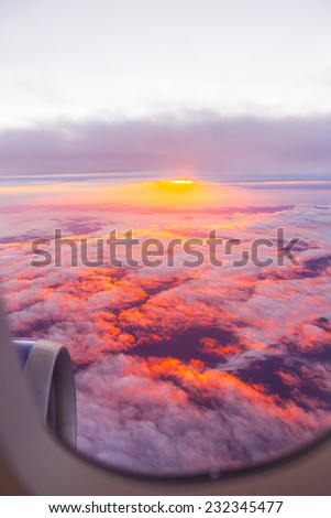 spectacular sunrise over the clouds seen from aircraft