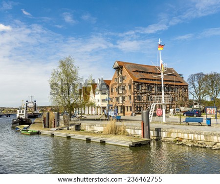 WOLGAST, GERMANY - APRIL 15, 2014: view to riverside of old village of Wolgast, Germany. The harbor at peene river ist restored ansd serves as tourist attraction.