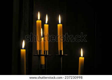Candles burning in a dark room without other light