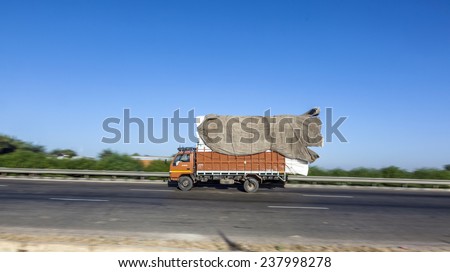 JEWAR BANGER, INDIA - NOVEMBER 12, 2011: truck uses the Yamuna express way in Jewar Banger, India. The Highway from Delhi to Agra is a toll road and was finally inaugurated at August 2011.
