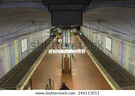 FRANKFURT, GERMANY - JAN 21, 2014: people wait at the metro station for the arriving train in Frankfurt, Germany. The Metro station was inaugurated 1978 after 8 years under construction.