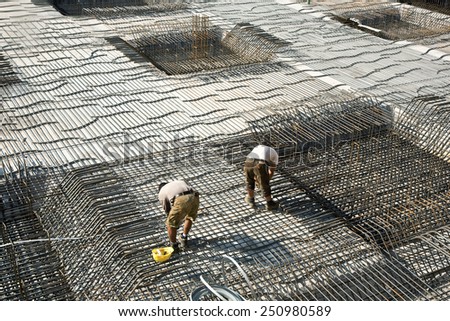 HOFHEIM, GERMANY - SEP 25: workers do the steel bars construction at a site on Sep 25, 2009 in Hofheim, Germany. The construction is checked by the Bauamt.