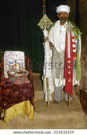 LALIBELA, ETHIOPIA - AUG 8, 2001: coptic priest is proud to present his church in Lalibela, Ethiopia. The coptic church dates back to 3d century AC in Ethiopia and is still vivid in the country.