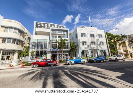 MIAMI, USA - AUG 5, 2013: The Art Deco district in Miami and a classic  car on Ocean Drive, South Beach, Miami, USA. Classic cars are allowed to park at yellow line.