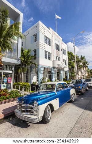 MIAMI, USA - AUG 5, 2013: The Art Deco district in Miami and a classic Dodge car on Ocean Drive, South Beach, Miami, USA. Classic cars are allowed to park at yellow line.