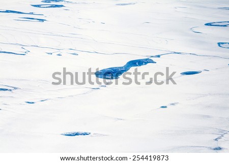 aerial of icy landscape in Alaska seen from aircraft