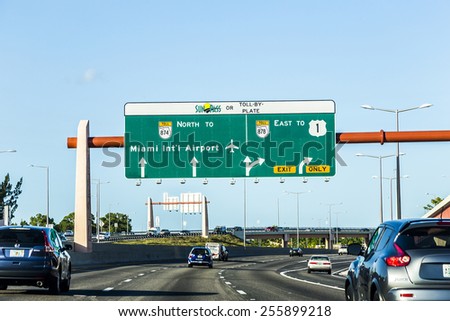 MIAMI, USA - AUG 27, 2014: driving the Miami Highway from the airport direction East in Miami, USA. Sunpass lane on left hand side is for toll only.