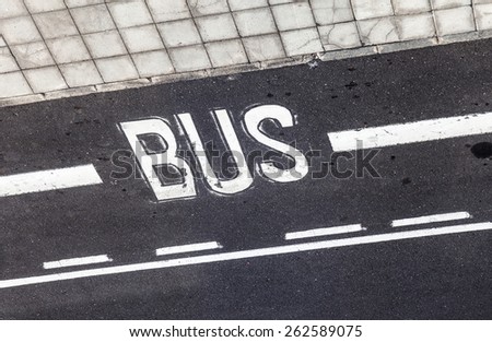 bus stop sign painted on the asphalt