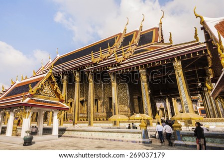 BANGKOK, THAILAND - JAN 4, 2010: people visit famous temple Phra Sri Ratana Chedi covered with foil gold in the inner Grand Palace in Bangkok, Thailand.