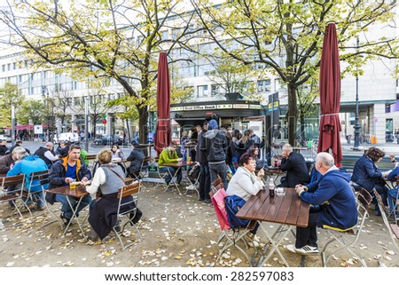 BERLIN, GERMANY - OCT 27, 2014: old vintage Kiosk name is renamed to oval office and people enjoy on tables the autumn summer in Berlin, Germany.