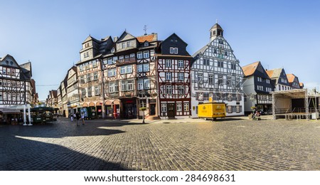 BUTZBACH, GERMANY - JUNE 4, 2015: people enjoy the beautiful medieval market place in Butzbach, Germany. In 143 the market place was build with cobble stones and the still existing fountain.