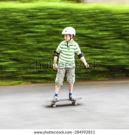 boy skating with speed with green blurred background