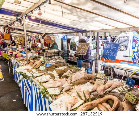 PARIS, FRANCE - JUNE 13, 2015: people buy at street market in Chaillot, Paris, France. At that6 farmers market people sell their fresh  own high quality products.