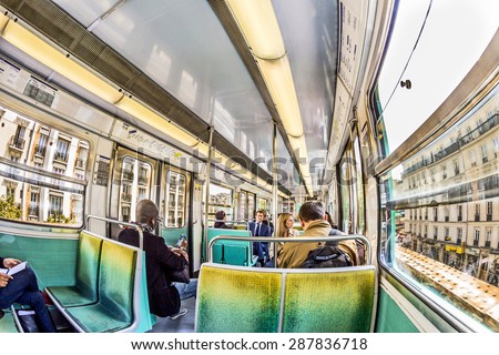 PARIS , FRANCE- JUNE 10, 2015: Tourists and locals on a subway train in Paris, France. More than 30 million people visit Paris annually.