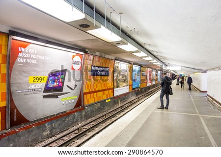 PARIS , FRANCE- JUNE 10, 2015: Tourists and locals on a subway train station in Paris, France. More than 30 million people visit Paris annually.