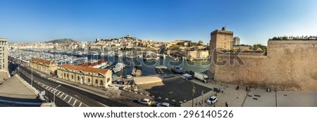 MARSEILLE, FRANCE - JULY 9, 2015: people enjoy the evening walk at the old harbor in Marseilles, France. The old harbor was founded by the romans and remains still exist nowadays.