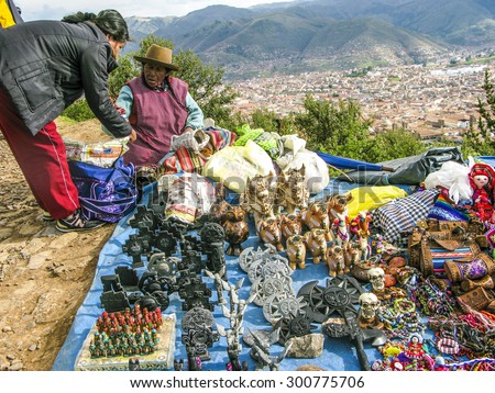 CUSZO, PERU - JAN 16, 2015: indian woman sells souvenirs to tourists in Cuzco, Peru to earn some money.