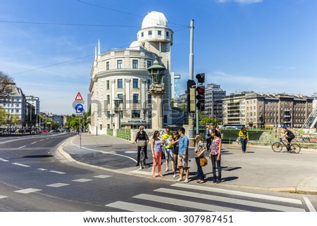 VIENNA, AUSTRIA - APR 25 2015: People at  Urania in Vienna. Urania is a public educational institute and observatory  built according to the plans of Art Nouveau style architect Max Fabiani in 1910.