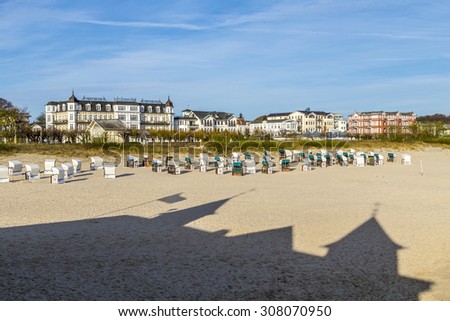shadow of famous pier in Ahlbeck at the beach with beach chairs and skyline of Ahlbeck