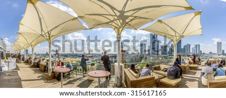 FRANKFURT, GERMANY - SEP 11, 2015: people enjoy the  view from the panorama platform to the skyline in Frankfurt, Germany. The Kaufhof platform is open to public from 9.30 am to 9 pm and is free.