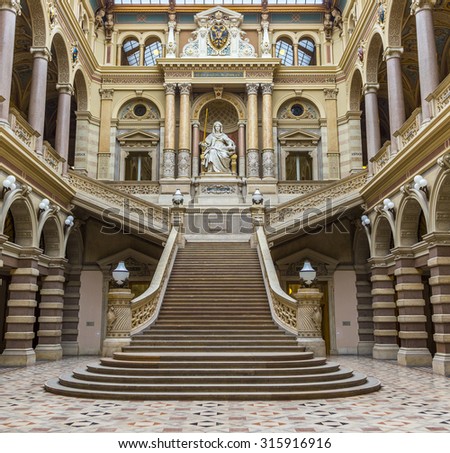 VIENNA, AUSTRIA - APR 27, 2015: neo renaissance building with statue Justice in the palace of Justice in Vienna, Austria. The palace is the seat of the supreme court in Austria.