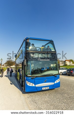 MUNICH, GERMANY - APR 20, 2015: people enjoy Munich by hop on hop off busses in Munich, Germany. These busses cover the most popular landmarks on their route.