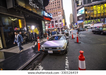 NEW YORK, USA - AUG 21, 2015:  people admire the famous original amc chrome car from the film back to the future presented at time square due to 25th anniversary of the Hollywood film.