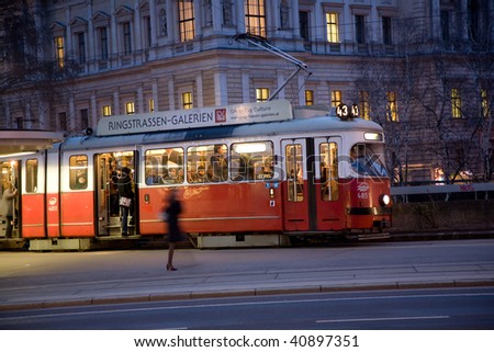 red old trolley car in Vienna in the first District by night