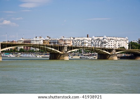 view over river danube in Budapest to renovated living houses and the bridge over the river